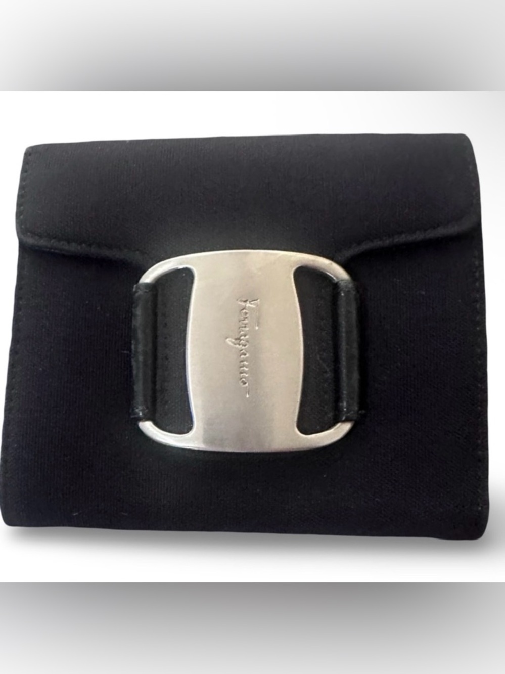 black Salvatore Ferragamo Vara canvas pouch with a silver-tone buckle.